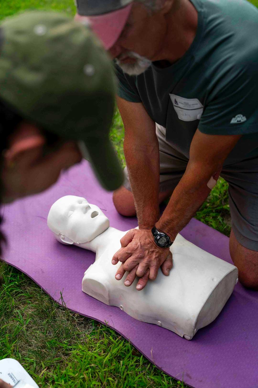 man-practices-cpr-on-a-training-dummy-outdoors-4uca7wlm4fo